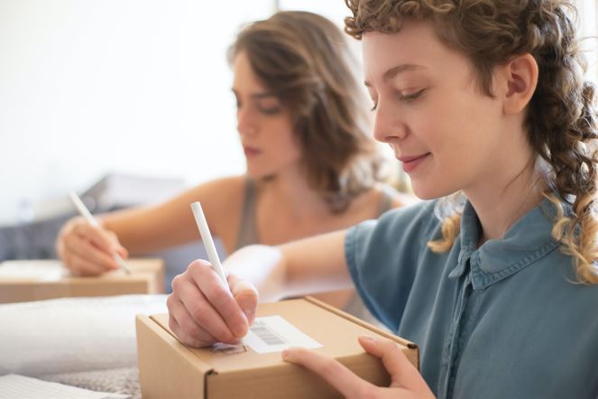 Colaboradores de loja virtual embalando encomendas para entrega